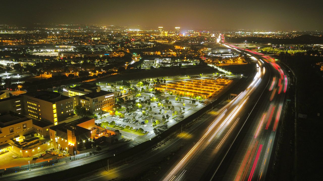 Night view of city lights and a highway with light trails