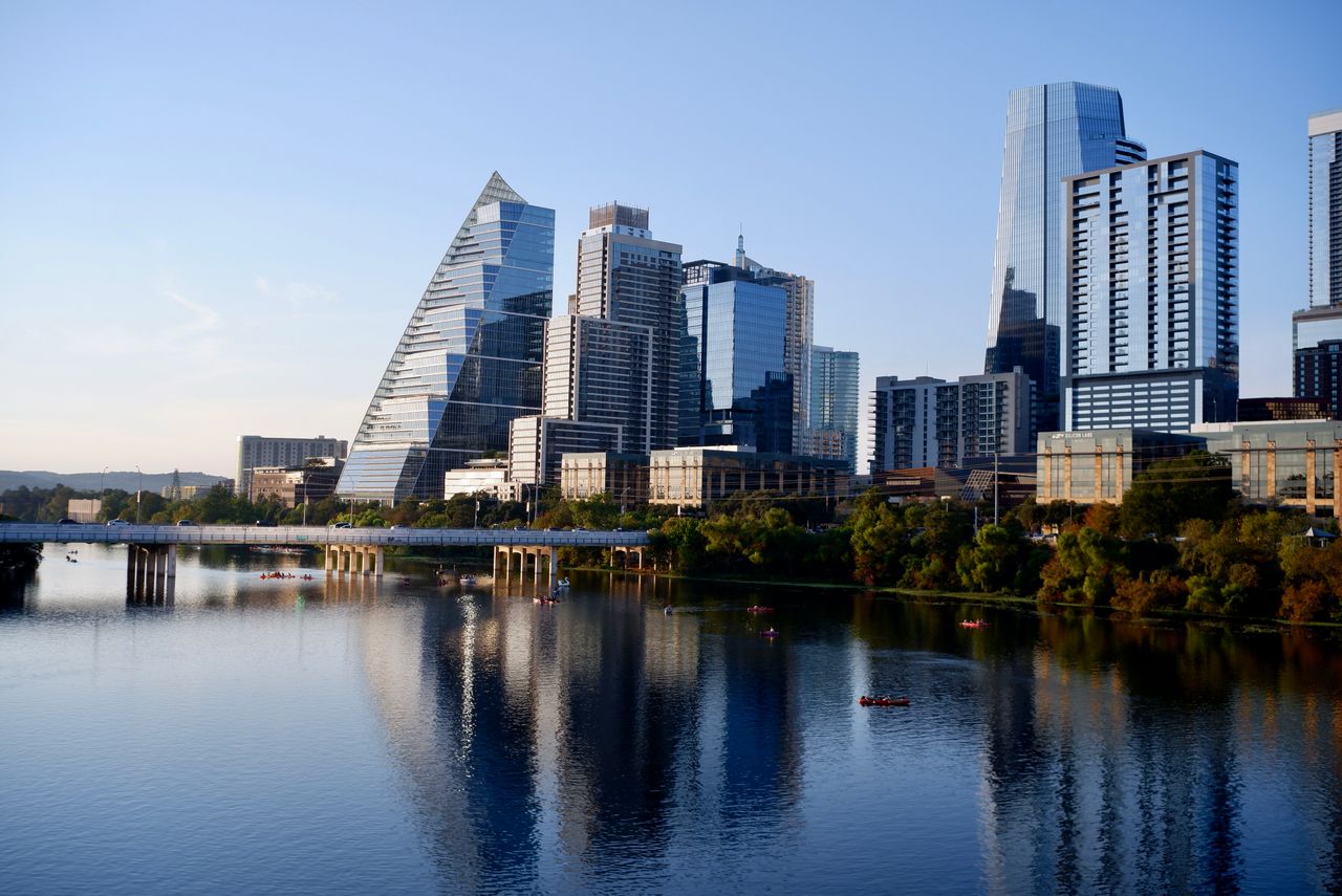 Austin skyline reflected in the lake under a clear sky