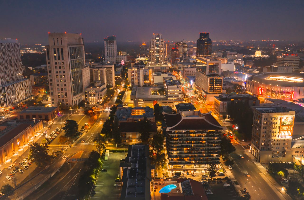 Downtown streets lit up at night, seen from above