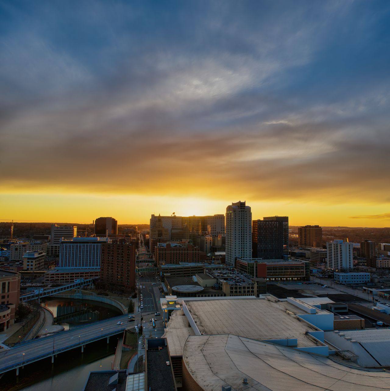 Downtown skyline under a dramatic sunset sky
