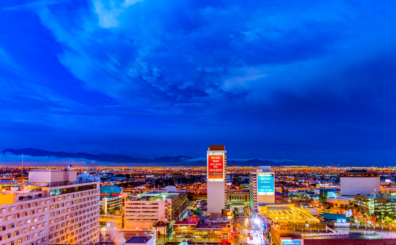 City lights at night under a deep blue sky