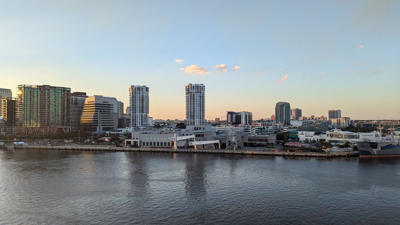 Waterfront city skyline across the bay at sunset