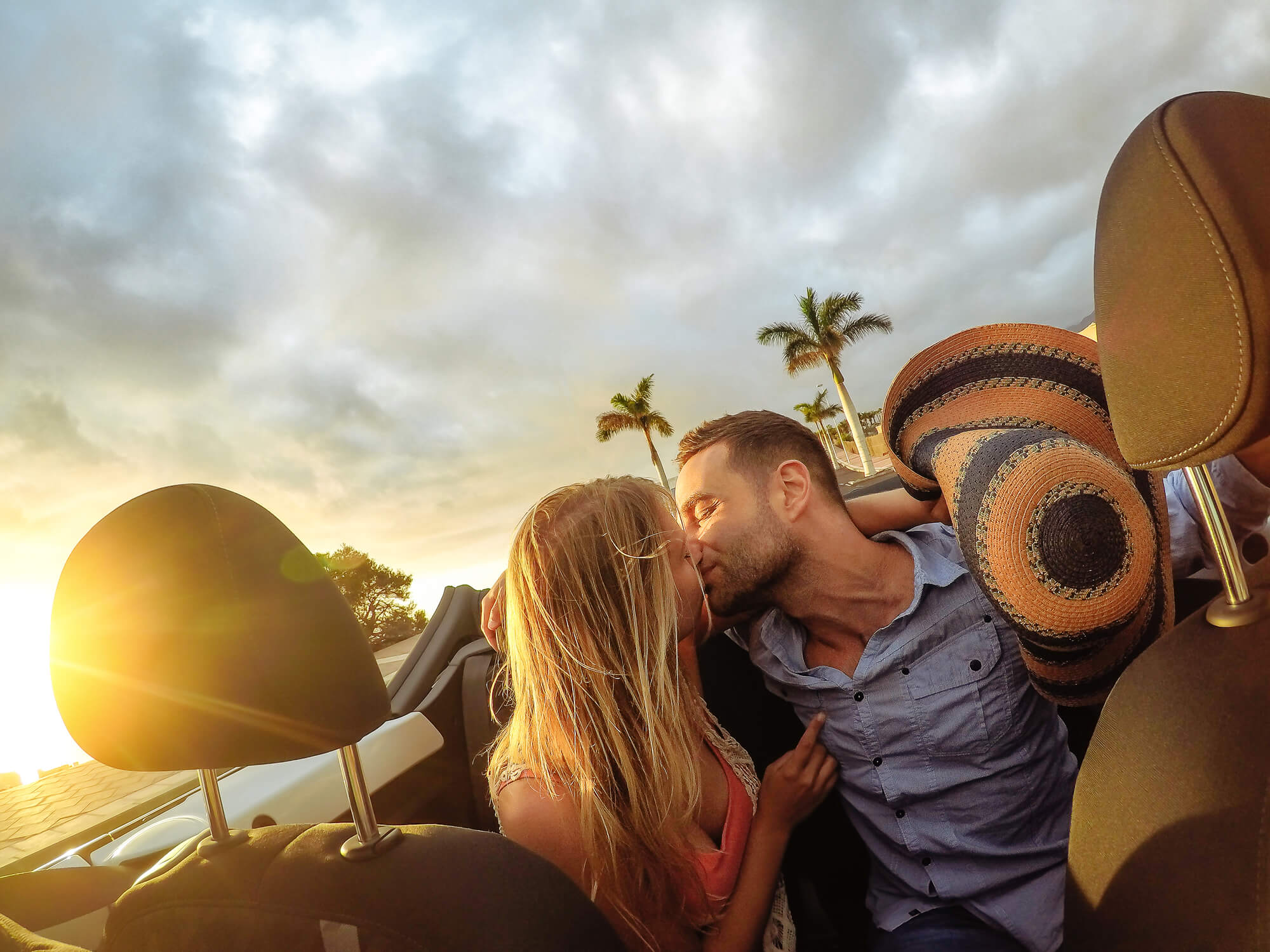 couple in an expensive convertible